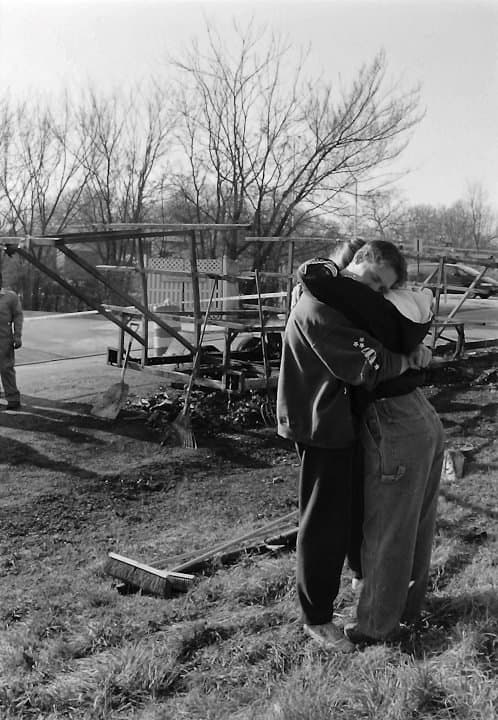 Two UTC Rowing athletes embracing at the burn site, the morning of March 22, 1996.