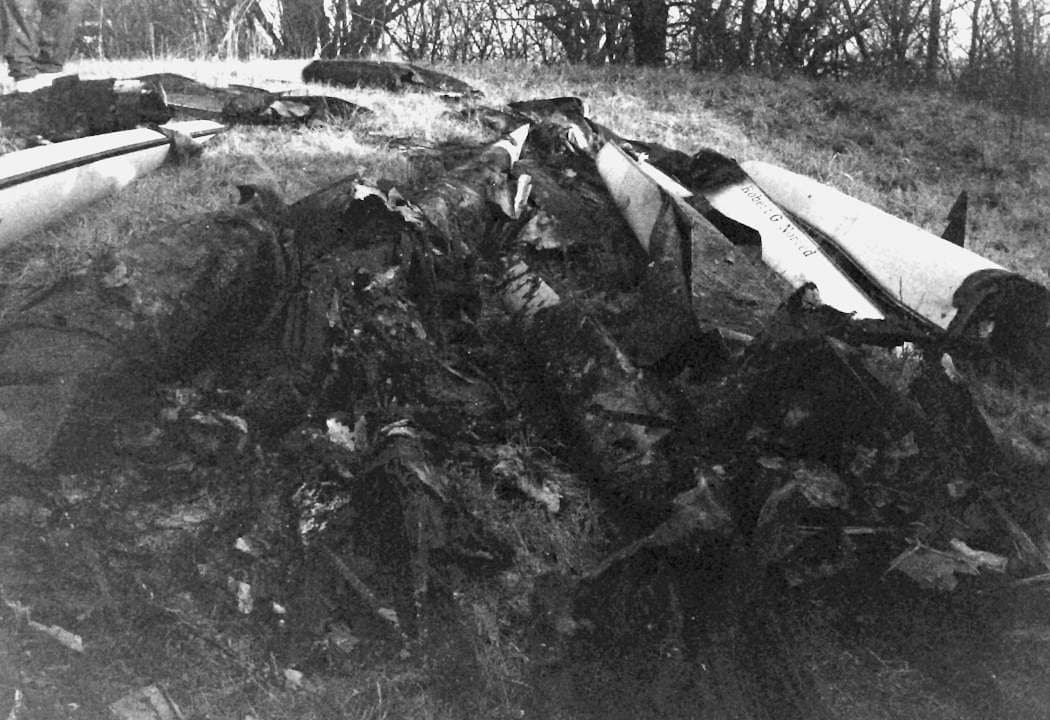 Stacked charred shell pieces with the 'Robert G. N…' nameplate visible at the right.
