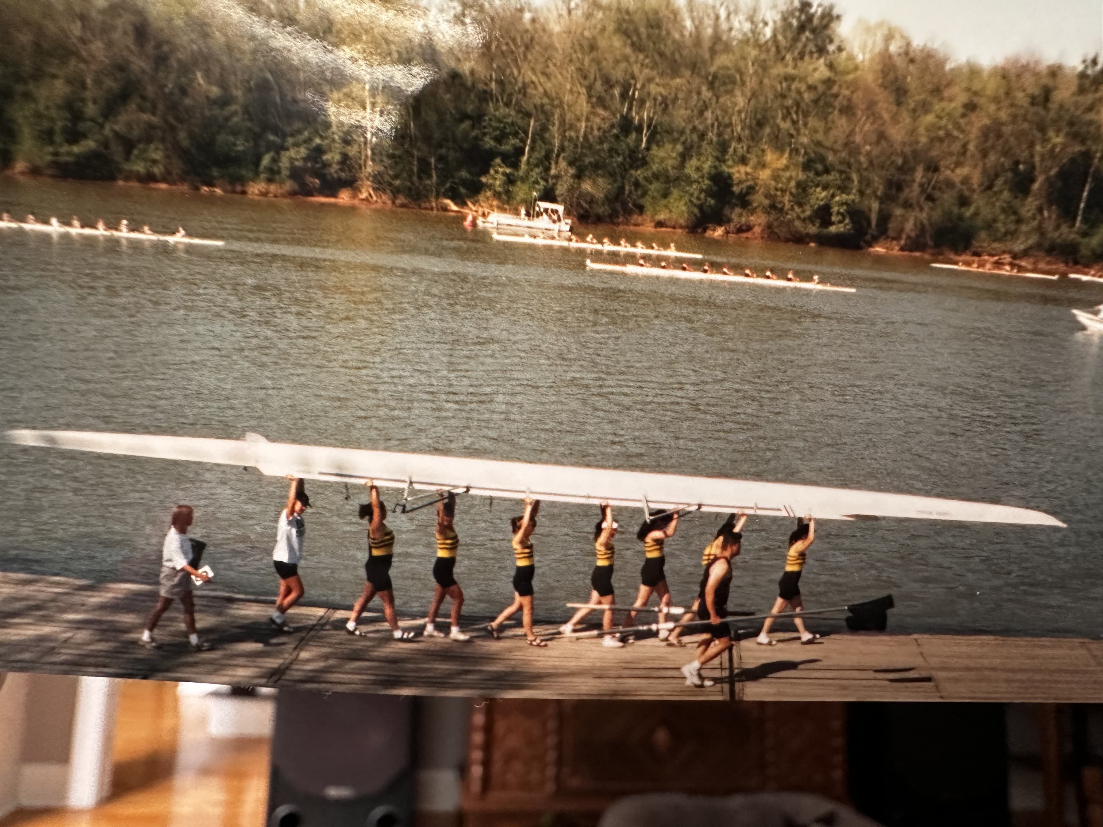 Women's 8+ portage on a dock