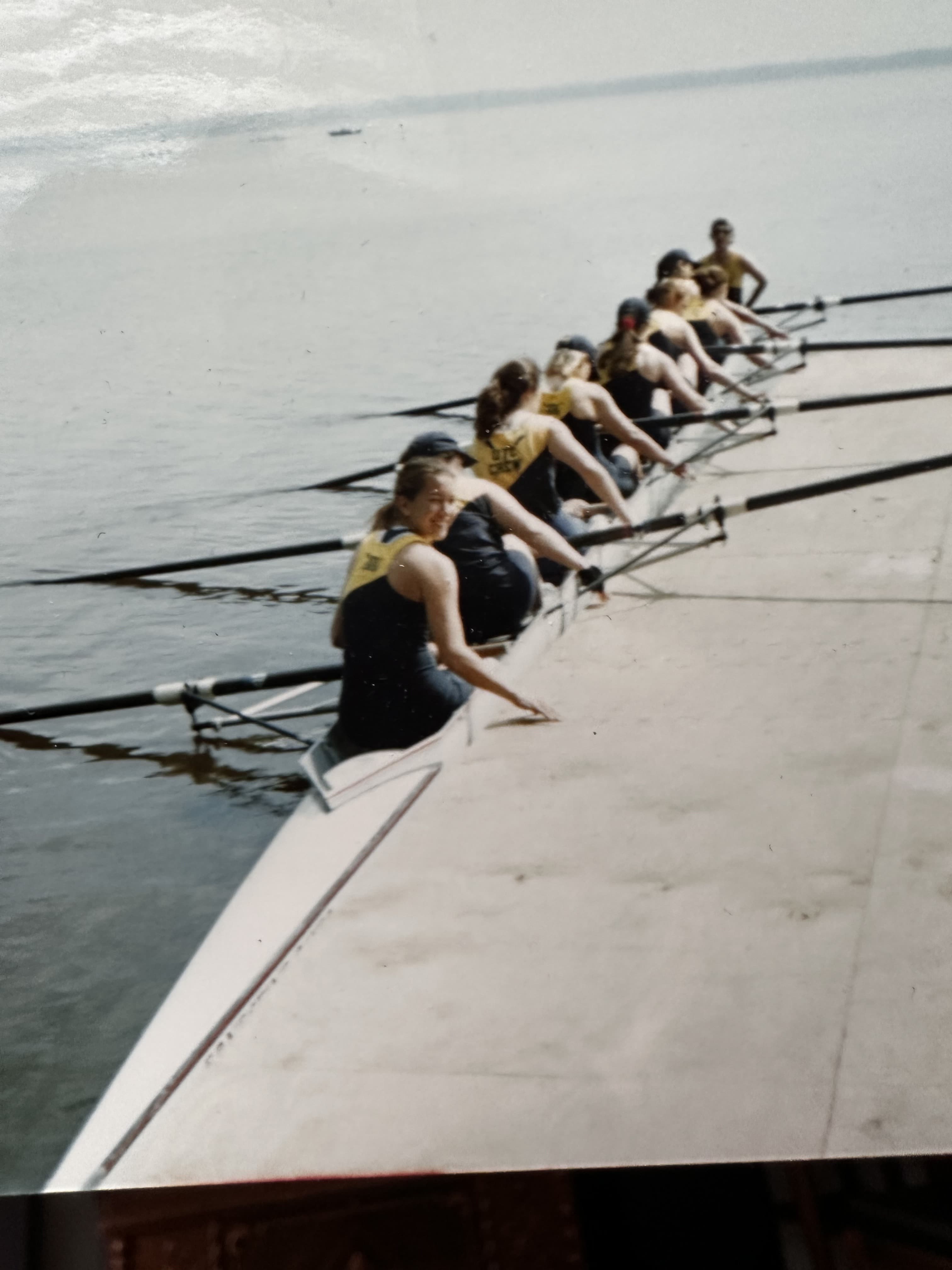 Women's 8+ rowing on the river (low-angle action shot)